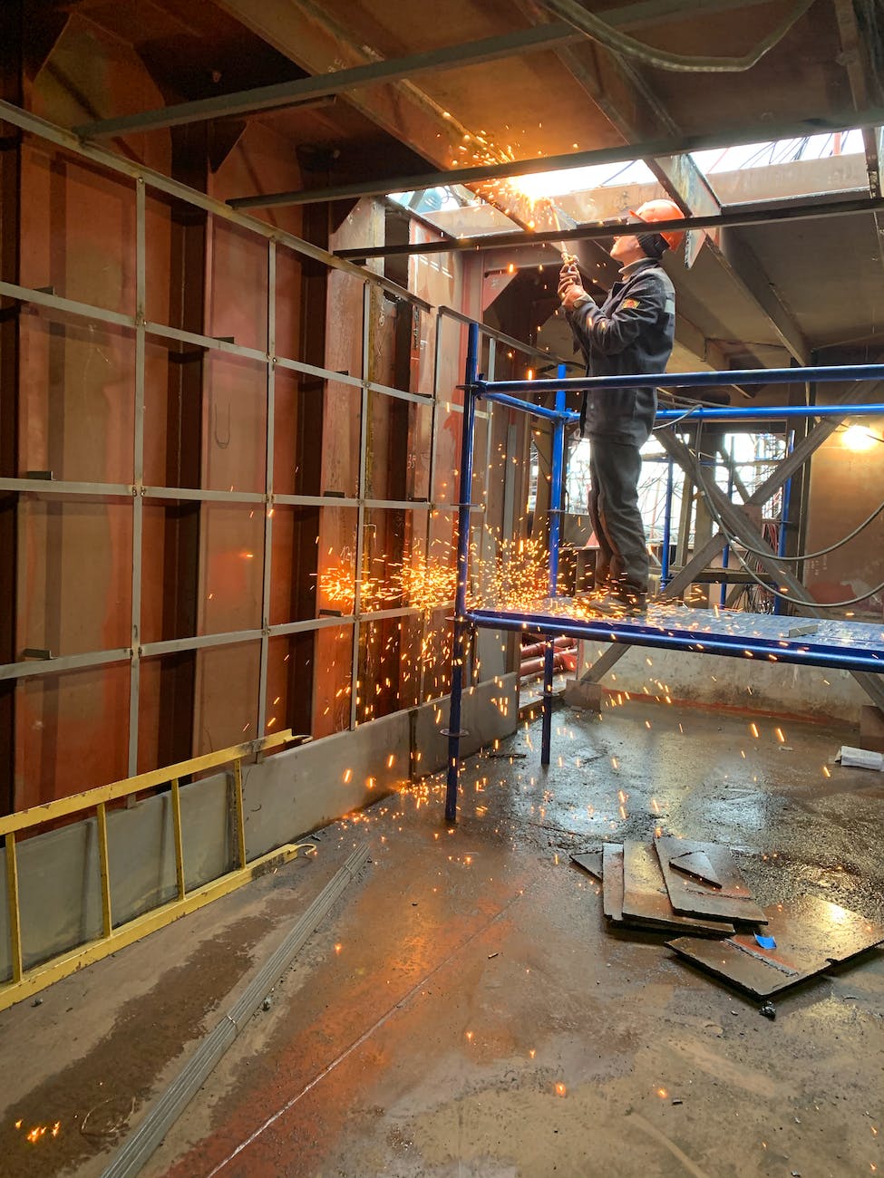 welder working inside industrial building